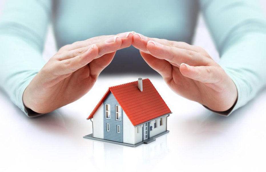 Fotografija: hands covering house - insurance concept - real estate