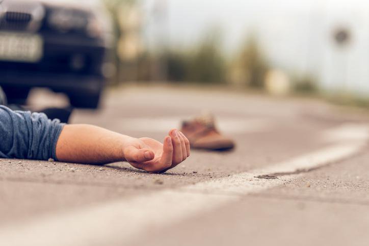 Fotografija: Car hit scene, male person lying on the floor in front of a car FOTO: Sestovic Getty Images/istockphoto