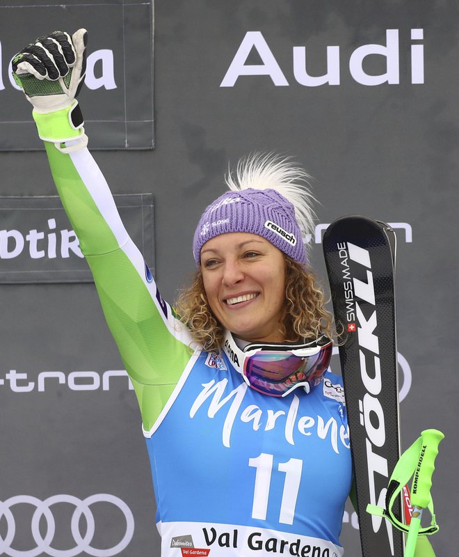 First placed Slovenia's Ilka Stuhec celebrates on the podium of an alpine ski, women's World Cup Super-G, in Val Gardena, Italy, Wednesday, Dec. 19, 2018. Stuhec finished a slim 0.05 seconds ahead of Tina Weirather of Liechtenstein and Nicole Schmidhofer of Austria, who tied for second. (AP Photo/Alessandro Trovati)