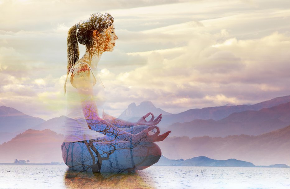 Fotografija: Double exposure of silhouette of woman doing yoga in lotus position over lake landscape. Concept of connection with the universe and nature.