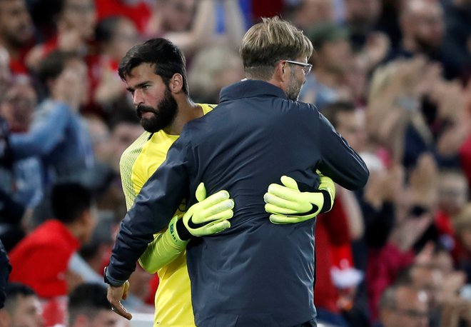 Vratar Alisson Becker (levo) in Jürgen Klopp se bosta morala izkopati iz blata, v katerega sta zabredla. FOTO: Carl Recine/Reuters