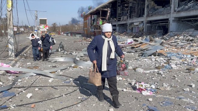 Ljudje bežijo pred rusko invazijo na Ukrajino v Buči v Ukrajini. FOTO: Reuters
