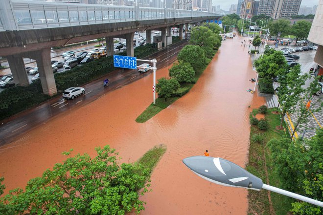 Poplavljene ceste na kitajskih ulicah. OUT FOTO: Str Afp