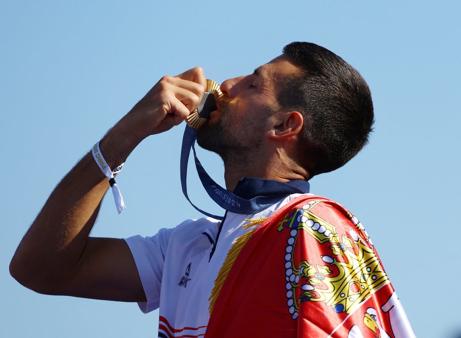 Fotografija: Po osvojitvi medalje. FOTO: Stephanie Lecocq Reuters